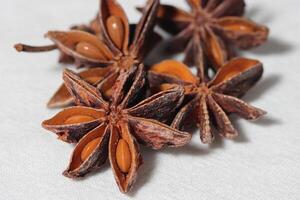 Star anise. Some star anise fruits with seed. Macro close-up on the jute burlap surface in rustic style. photo
