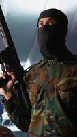 Vertical Terrorist holding rifles attacking enemy command post, looking around for threats. Insurgent inspecting room during enemy base assault hijacking in guerilla warfare armed conflict, camera B video