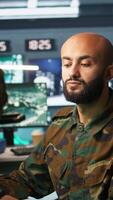 Vertical Army telecommunication systems operator using radio and satellite gear to gather intel, providing combat support. Special forces military dispatcher managing communications networks, camera B video