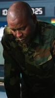 Vertical Team of soldiers looking at screens in command center housing operational missile defense system designed to intercept ballistic rockets. Tracking equipment operators using radar systems, camera A video
