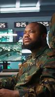 Vertical Soldiers working in governmental facility, doing surveillance with digital radar equipment, operating missile systems. Man monitoring army HQ CCTV for any unauthorized activity, camera B video