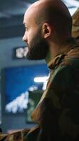 Vertical Soldier doing tasks in military base, doing surveillance with digital radar equipment, operating missile systems. Middle Eastern man monitoring army HQ CCTV for any unauthorized activity, camera A video