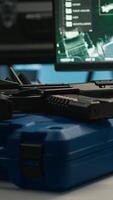 Vertical Weapons on table in empty control center housing operational missile defense system designed to intercept ballistic threats. Close up of guns in army headquarters used for tracking rockets with radar video