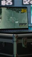 Vertical Air force officer performing tactical level surveillance in command room using laptop. Close up of military specialist in base of operations using radar on notebook to look at assault zones, camera A video