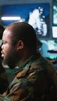 Vertical Soldier doing tasks in military base, using radar, intercepting and destroying ballistic rockets. Man monitoring army HQ CCTV for any unauthorized activity, tracking missiles, camera A video