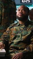 Vertical Military officer using augmented reality tracking tech to gain info helpful against enemies. Army expert using AR hologram to gain intel helping troops, coordinating mission activities, camera A video