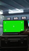 Vertical Army telecommunication systems operator using green screen gear, providing combat support. Military dispatcher managing communications networks with mockup laptop, camera B video