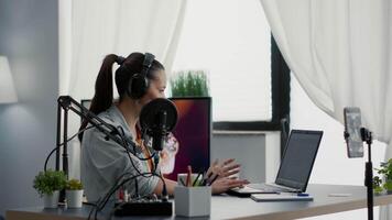 Popular internet streamer answering public question on live chat while broadcasting . Young digital content creator talking to audience while recording daily vlog at home. video
