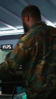 Vertical Air force officer performing tactical level surveillance in command room using laptop. Close up of military specialist in base of operations using radar on notebook to look at assault zones, camera B video