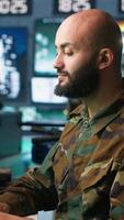 Vertical Army specialist employing AI tech to improve military warfare systems and threat monitoring. IT admin uses neural networks to enhance combat operational capabilities, camera A video
