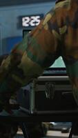 Vertical Military soldier wearing camo uniform in mission control center, overseeing national safety operations using laptop. Army expert examining data in monitoring room command center, camera A video