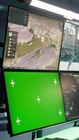 Vertical Air force officer performing tactical level surveillance in command room using mockup screen. Military specialist using radar on chroma key gear to look at assault zones, camera B video