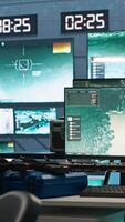 Vertical Secure room in army governmental facility operating as military command post and surveillance monitoring center, filled with digital equipment. Empty military base of operations with radar systems video