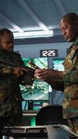 Vertical Operatives conducing special operation, loading pistol, preparing to attack enemy troops. Close up of military unit in command center packing handgun for assault mission, camera B video