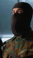 Vertical Terrorist holding rifles attacking enemy command post, looking around for threats. Insurgent inspecting room during enemy base assault hijacking in guerilla warfare armed conflict, camera A video