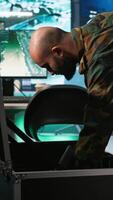 Vertical Army soldiers in command center packing weapons able to engage targets at extended range. Military units reloading gun cartridge, preparing for enemy assault mission, camera A video