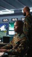 Vertical Army professional employing AI tech to improve military combat systems and missiles monitoring. African american IT admin uses neural networks to enhance combat operational capabilities, camera B video