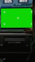 Vertical Army specialist working in war room operating surveillance tech, evaluating target data on isolated screen laptop. Soldier engaging enemy forces using chroma key notebook, camera A video