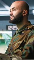 Vertical Special forces professional in military HQ base gathering information on enemy troops. Officer using monitoring equipment in base of operations to do assessment of enemy vulnerabilities, camera A video