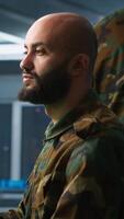 Vertical Military agent working in control room, analyzing aerial reconnaissance data. Intelligence corps agent controlling drones attacking strategic targets, camera A video