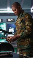Vertical Operatives conducing special operation, doing checkup on rifles and pistols, preparing to attack enemy. African american military units in command post packing guns for assault mission, camera B video
