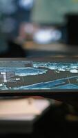 Vertical Army operative using tablet in command center housing operational missile defense system designed to intercept ballistic rockets. Close up of expert using tracking software on device, camera A video