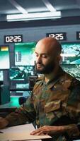 Vertical Tired military officer receiving intel folder on enemy, feeling fatigued. Overworked army specialist feeling exhausted while reading mission case file to collect data on opponents strategy, camera B video