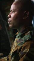 Vertical Army professional employing AI tech to improve military combat systems and missiles monitoring. African american IT admin uses neural networks to enhance combat operational capabilities, camera A video