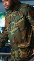 Vertical Intelligence corps expert in military HQ base gathering information on enemy troops. Officer arriving at work in base of operations, starting assessment of enemy vulnerabilities, tracking, camera A video