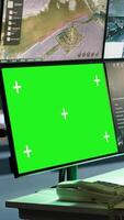 Vertical Masked intelligence corps agent overseeing national safety operations with mockup equipment. Special forces spy examining data in monitoring room with chroma key monitors, camera A video