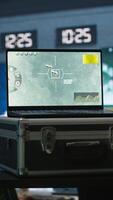 Vertical Air force combat control agent performing tactical level surveillance in war room using laptop. Military expert in base of operations using radar on notebook to look at assault zones, camera A video