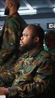 Vertical Military soldier in mission command post overseeing national safety operations, talking on phone. African american army expert in telephone call in monitoring room, camera B video
