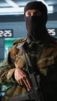 Vertical Terrorist occupying enemy base of operations, conducting guerilla warfare. Rebel forces hijacker with firearm in hidden war room starting offensive against opponents, camera A video