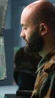 Vertical Army computer scientist employing AI technology in military planning and decision making processes. Expert uses artificial intelligence to enhance armed forces operational capabilities, camera A video