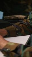 Vertical Special forces military agent working in control room, analyzing aerial reconnaissance data. Close up of intelligence corps expert controlling drones attacking strategic targets, camera A video
