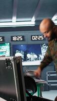 Vertical Army soldiers in command center packing weapons able to engage targets at extended range. Military units reloading gun cartridge, preparing for enemy assault mission, camera B video
