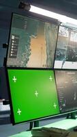 Vertical Masked intelligence corps agent overseeing national safety operations with mockup equipment. Special forces spy examining data in monitoring room with chroma key monitors, camera B video