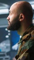 Vertical Soldier doing patriotic duty in military HQ base, gathering information on enemy troops. Officer using high tech monitoring gear to do assessment of enemy vulnerabilities, camera A video