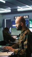Vertical Army computer scientist employing AI technology in military planning and decision making processes. Expert uses artificial intelligence to enhance armed forces operational capabilities, camera B video