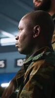 Vertical Team of army telecommunications operators using radio and satellite gear, cooperating to provide combat support. Teamworking military dispatchers colleagues managing communications networks, camera A video