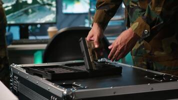 Operatives conducing special operation, loading weapons, preparing to attack enemy forces. Close up of army soldier in command center packing guns for assault mission, camera A video
