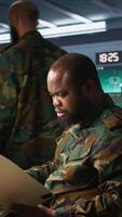 Vertical Military officer in command post receiving intel folder files on enemy battle formation. Intelligence specialist reading mission case file to collect data on opponents strategy, camera B video