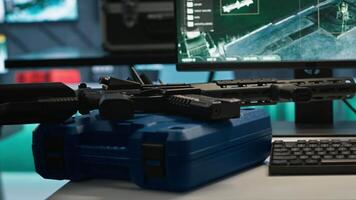 Weapons on table in empty control center housing operational missile defense system designed to intercept ballistic threats. Close up of guns in army headquarters used for tracking rockets with radar video
