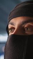 Vertical Terrorist hiding identity, attacking enemy command center. Close up of masked insurgent inspecting room during enemy base assault hijacking in guerilla warfare armed conflict, camera B video