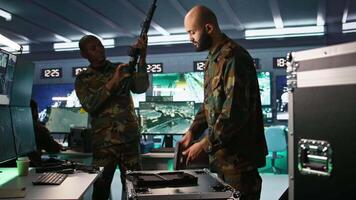 Operatives conducing special operation, loading weapons, preparing to attack enemy forces. Close up of army soldier in command center packing guns for assault mission, camera B video