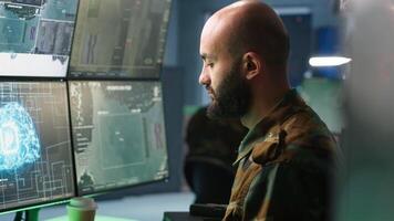 Army computer scientist employing AI technology in military planning and decision making processes. Expert uses artificial intelligence to enhance armed forces operational capabilities, camera A video