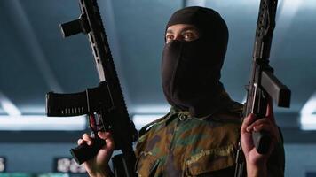 Terrorist holding rifles attacking enemy command post, looking around for threats. Insurgent inspecting room during enemy base assault hijacking in guerilla warfare armed conflict, camera A video