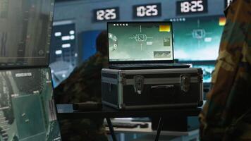 Military officer using tracking software on laptop to gain info helpful against enemies. Army professional using notebook to gain intel helping troops, coordinating mission activities, camera A video