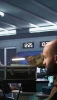 Vertical Military officer using tracking software to be able to offer info to front lines commander. Army expert doing reconnaissance to gain intel helping troops, coordinating mission activities, camera B video