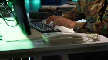 Military soldier in mission control center overseeing national safety operations with devices, close up. Middle Eastern army specialist examining data in monitoring room command center, camera A video